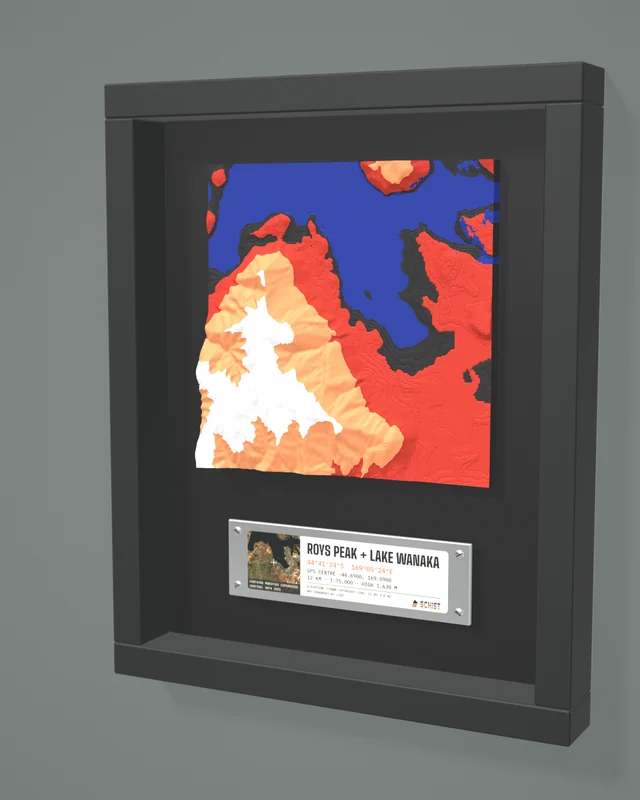 Render: the Roys Peak + Lake Wanaka tile in a dark shadow-box frame with a coordinate plate below it