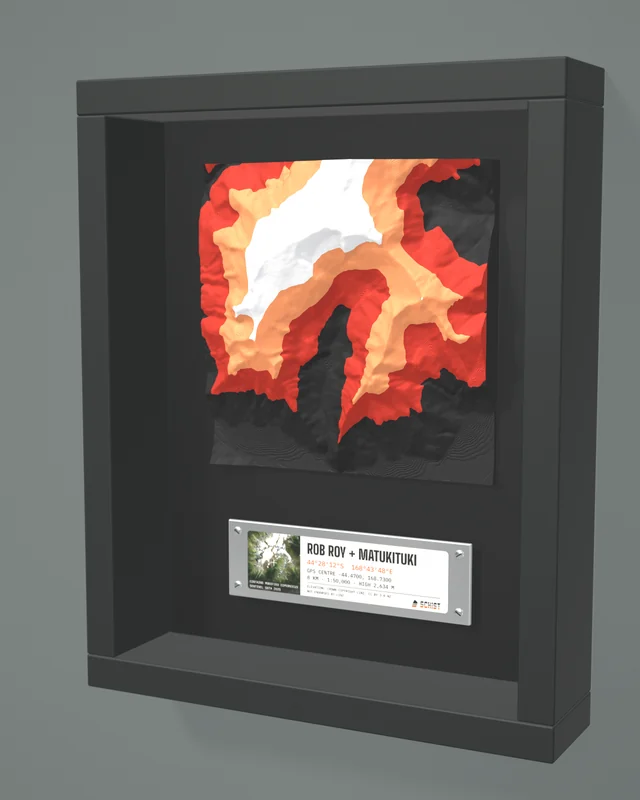 Render: the Rob Roy + Matukituki tile in a dark shadow-box frame with a coordinate plate below it