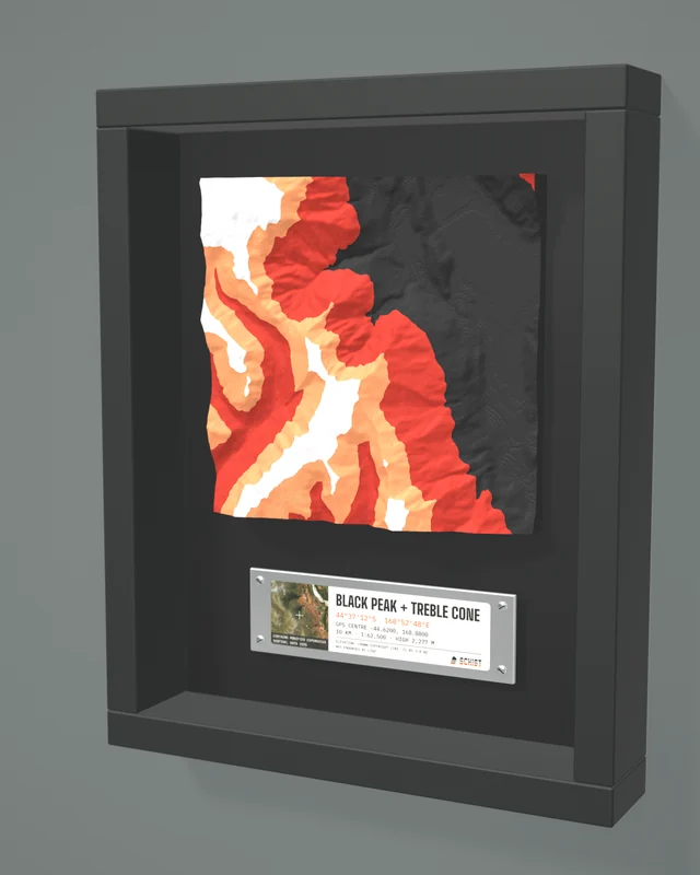 Render: the Black Peak + Treble Cone tile in a dark shadow-box frame with a coordinate plate below it