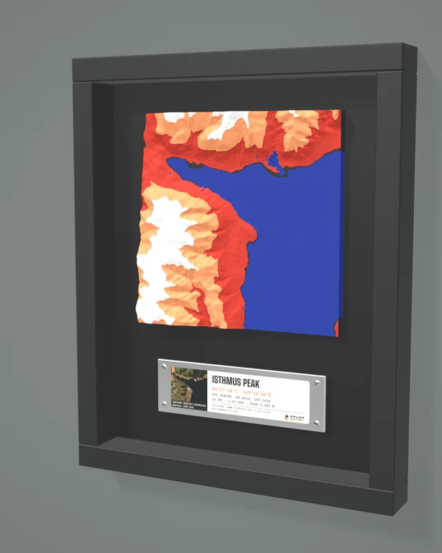 Render: the Isthmus Peak tile in a dark shadow-box frame with a coordinate plate below it